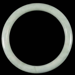 Good Jadeite Bangle: Good jadeite bangle of natural white/green color. Inner diameter: 2.25 inches (5.7 cm)