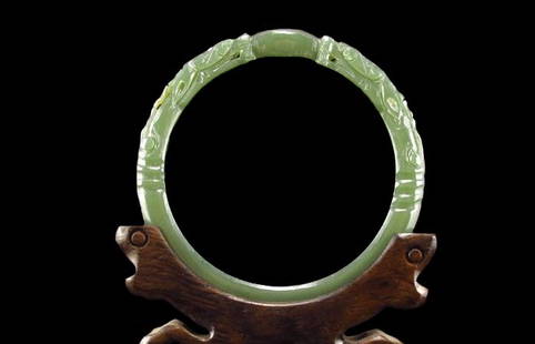 Translucent Deep Green Jade Dragon Bangle: Translucent Deep Green Jade Dragon Bangle. Finely polished and carved with two facing dragons. Inner diameter: 2.3 inches (5.8 cm) Provenance: Property of a discerning Asian collector of