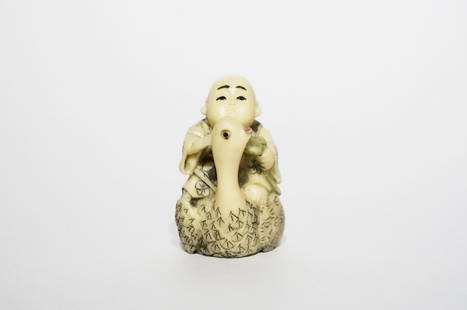 Antique Polycrome Ivory Netsuke: Antique polychrome ivory netsuke of a boy on a swan. Nicely carved with good polish. Height: 2 inches (5.1 cm)