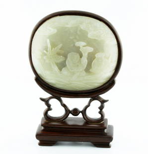 Very Fine White Jade Landscape Screen Plaque, Qing Dyn.: Very fine white jade landscape screen plaque, Qing dynasty. Circular jade plaque depicting a landscape scene with a boy holding a plant underneath clouds. Finely polished and mounted in a wood stand.