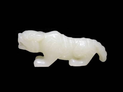 White Jade Tiger, 20th Century: Well carved white jade tiger, 20th Century. Length: 2.9 inches (7.4 cm)