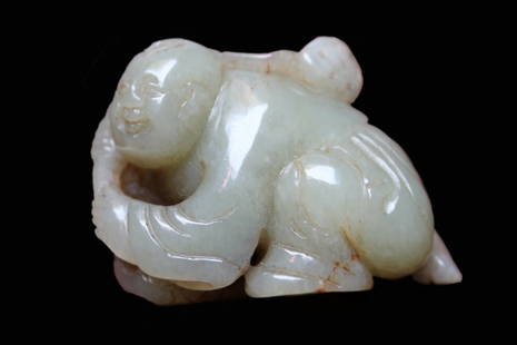 Antique Jade Carving of a Boy: Antique Jade carving of a boy. Shown kneeling on one leg holding a lotus pod branch. Length: 2.5 inches (6.35 cm)