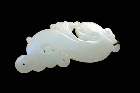 White Jade Dragon-Fish Pendant: White jade dragon-fish pendant. The coiled beast carved with fins from a translucent stone of even color. Length: 3 inches (7.6 cm)