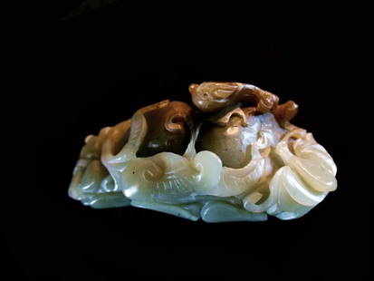 Fine Jade Carving Group, 19th Century: Fine Jade Carving Group, 19th Century. Celadon and brown jade carving of qilin surrounded by plants and overlapping foliage. Length: 3.6 inches (9.1 cm)