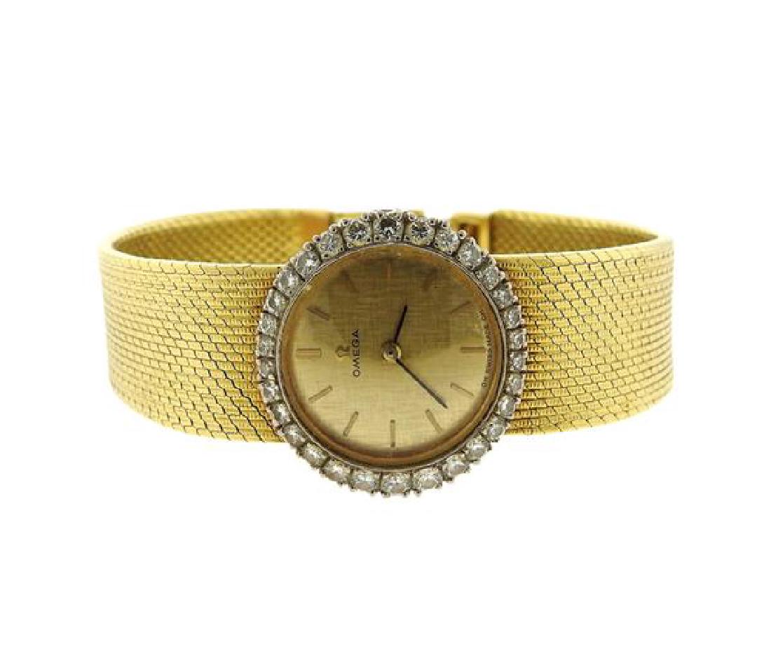Omega 18k Gold Diamond Manual Wind Lady's Watch: METAL: 18k gold. MEASUREMENTS: case - 23mm x 21mm. Band - 6 2/8" long. Gold tone dial with stick markers, diamond bezel. MOVEMENT: manual wind, running order. WEIGHT: 55.5 grams.Gemstones have no