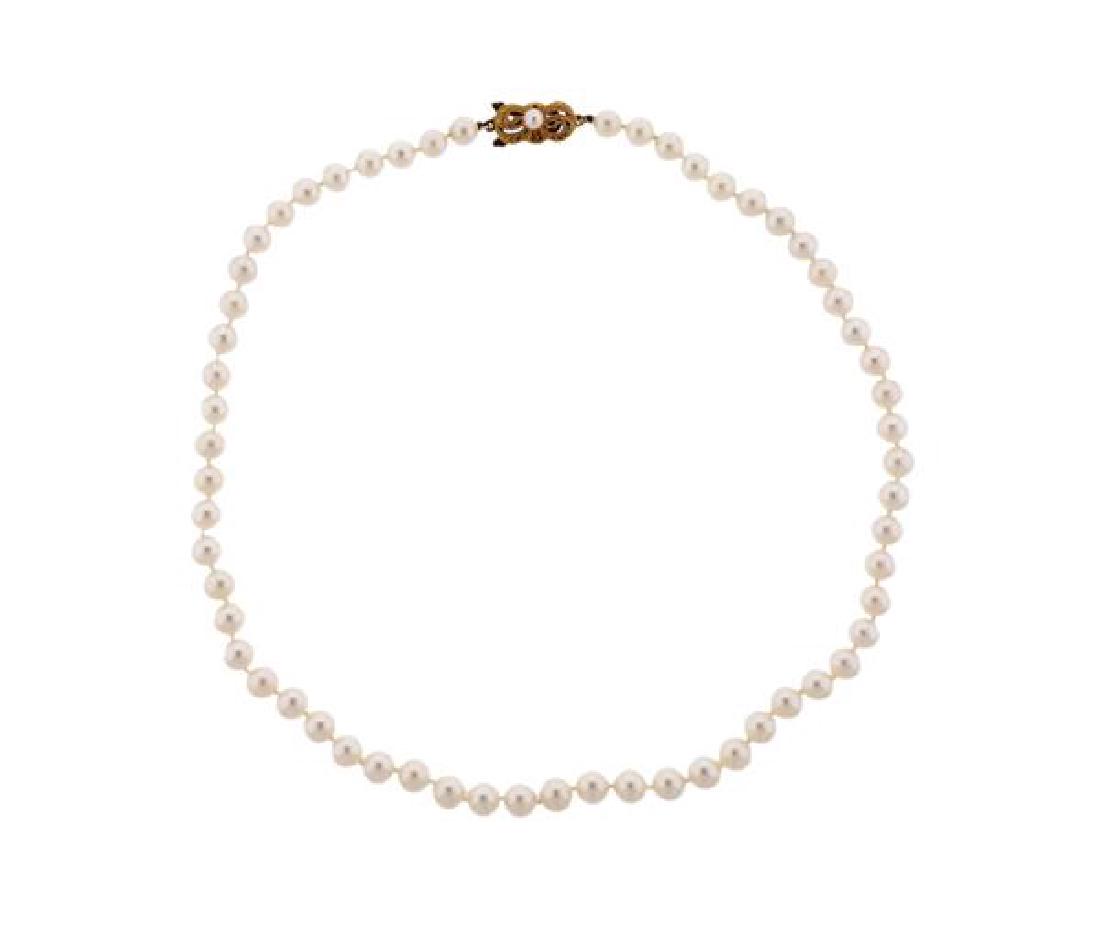 Mikimoto 18K Gold Pearl Necklace: METAL: 18K gold. GEMSTONES: pearls 6-6.5mm. MEASUREMENTS: necklace is 16.5" long x 6.5mm at widest point. MARKED: 750 maker's hallmark. WEIGHT: 22.2 grams. Retail: $3020Gemstones have not bee