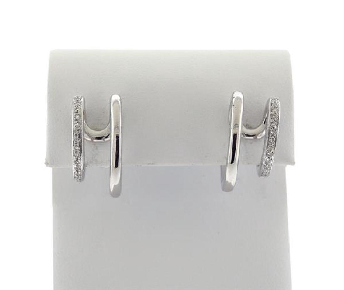 Antonini 18K Gold Diamond Half Hoop Earrings: METAL: 18K Gold. GEMSTONES: Diamonds - approx. 0.16ctw. MEASUREMENTS: Earrings measure 21mm x 20mm x 9.8mm wide. MARKED: Antonini, 750. WEIGHT: 14.98 grams. Gemstones have not been graded for color an