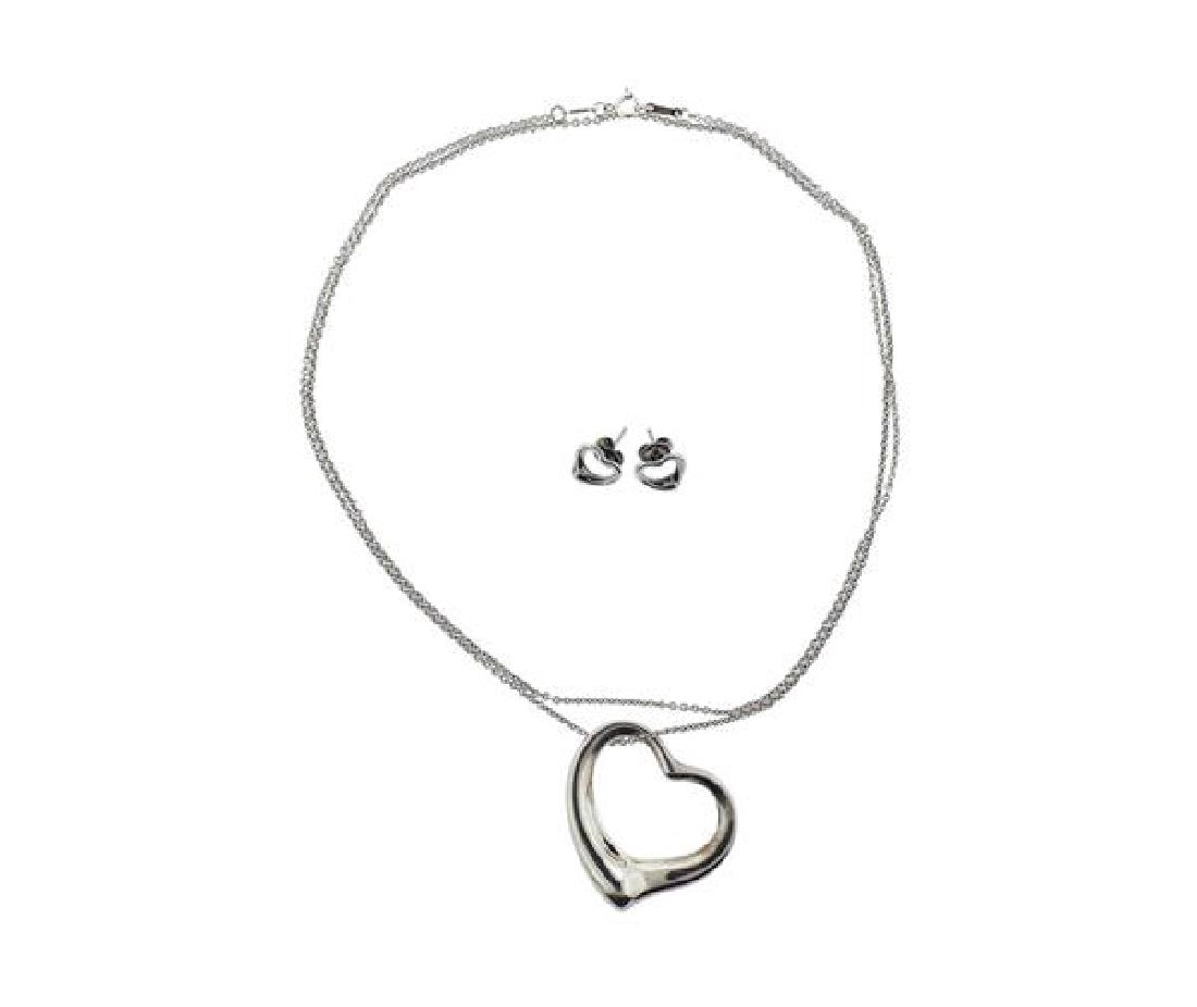 Tiffany & Co Peretti Sterling Heart Necklace: METAL: sterling silver. MEASUREMENTS: necklace is 30" long. Heart pendant is 32mm x 35mm at widest point. Heart earrings are 10.7 x10.7mm. MARKED: Tiffany & Co Elsa Peretti 925 Spain. WEIGHT: