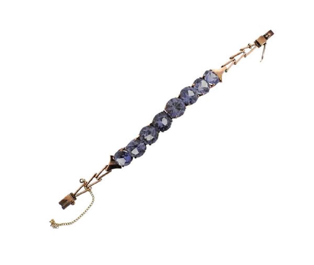 14K Gold Color Stone Bracelet: METAL: 14K gold. GEMSTONES: color stones, have blue and purple hues. MEASUREMENTS: bracelet is 6" long x 11.5mm at widest point. Safety chain is not original and unattached on one end. TESTED: 14