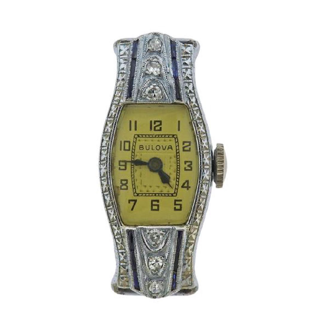 Art Deco Bulova 14k Gold Platinum Diamond Watch: METAL: 14k Gold / Platinum. MEASUREMENTS: Case - 32mm x 14mm excl crown. Case decorated with diamonds and sapphires. Dial signed Bulova, with black arabic numerals. MOVEMENT: Manual wind, running orde