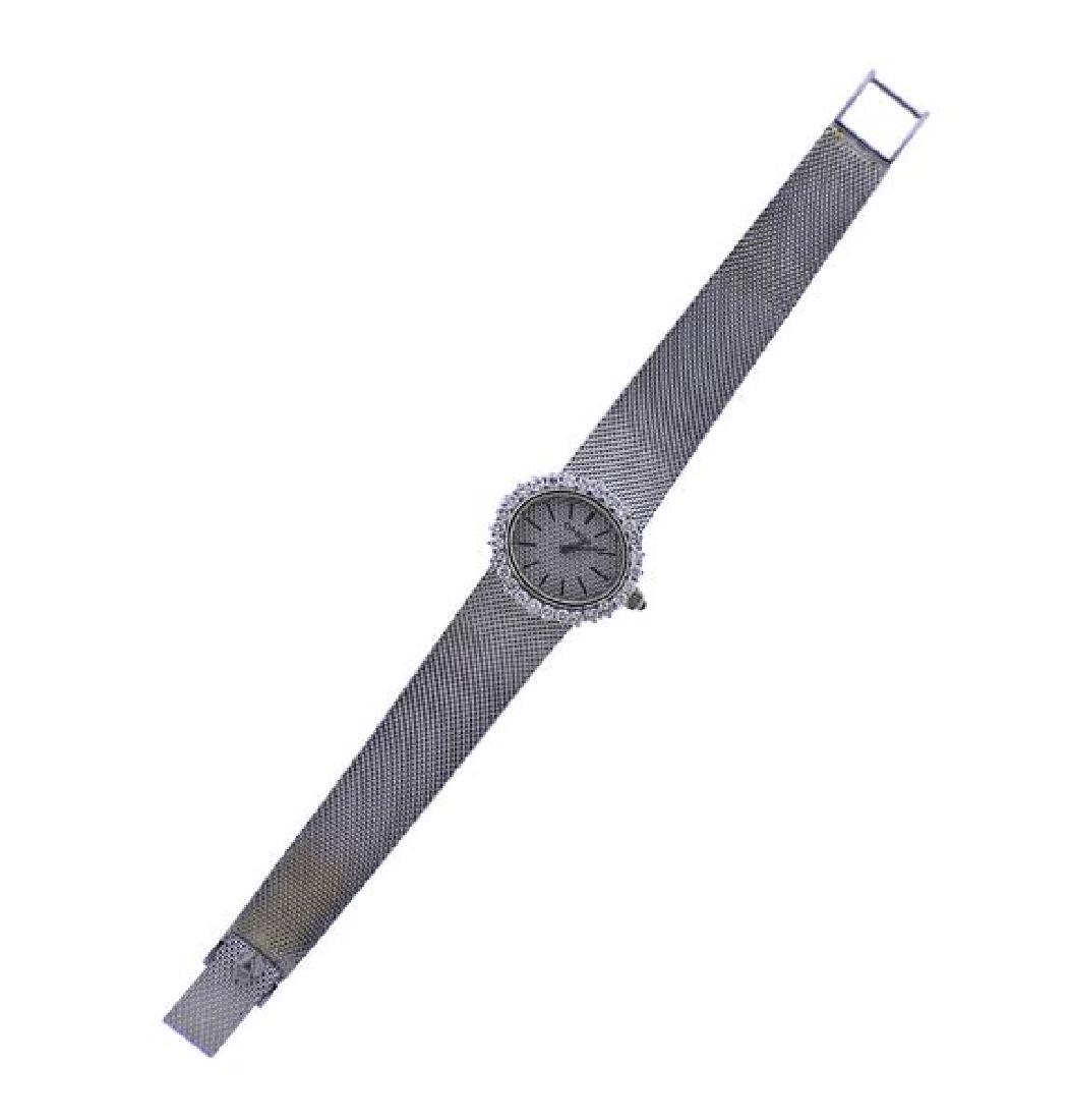 Omega 18k Gold Diamond Manual Wind Watch: METAL: 18k gold. GEMSTONES: 28 diamonds, sapphire. MEASUREMENTS: case -23mm excl. crown x 22mm. 18k gold band is 6 3/4" long, diamond bezel. Silvered dial with silver markers. MOVEMENT: manual wi