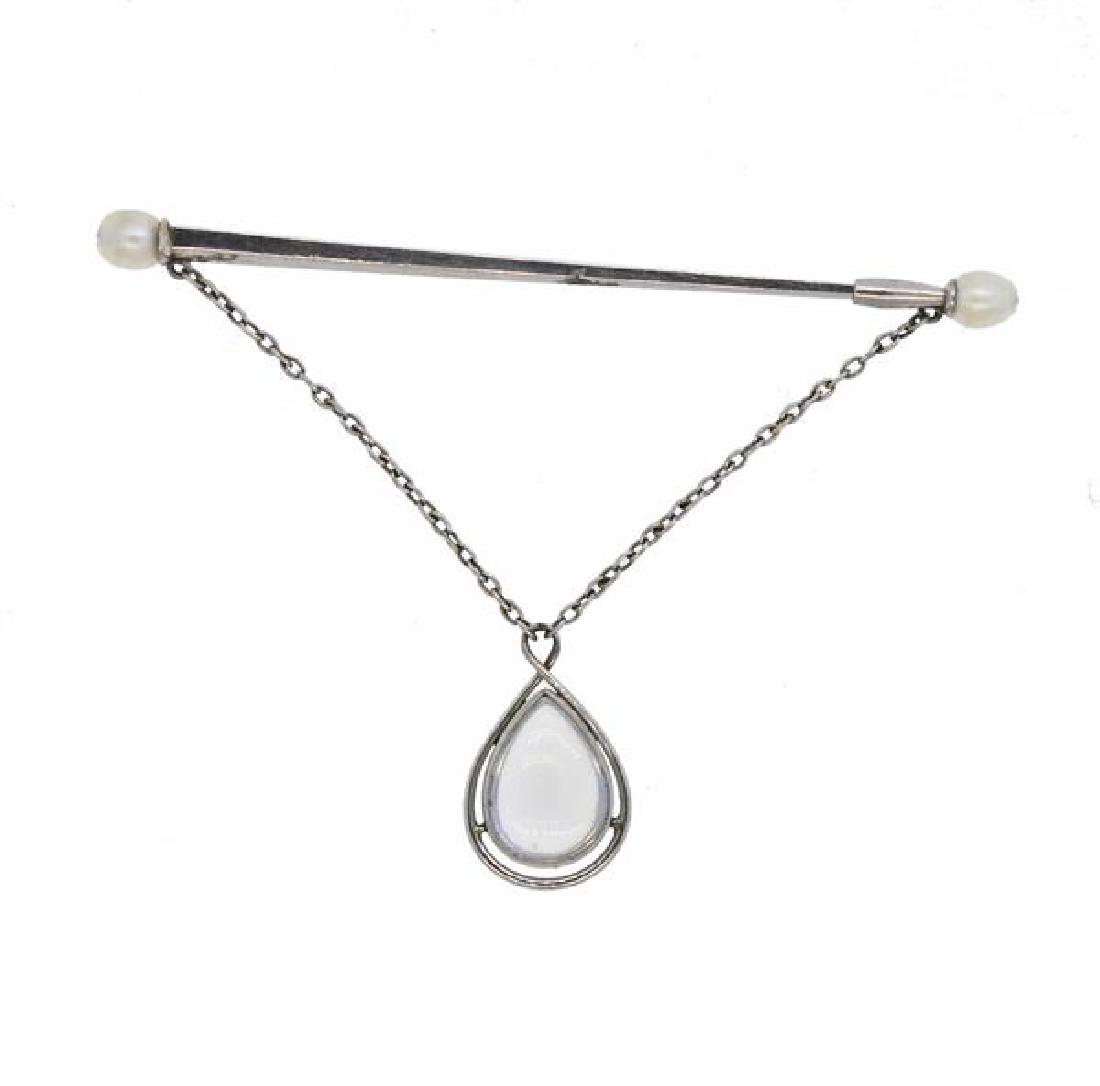Antique Platinum Pearl Moonstone Pin: METAL: platinum. GEMSTONES: pearls, moonstone. MEASUREMENTS: pin measures 52mm x 35mm at widest point. TESTED: platinum. WEIGHT: 2 grams.Gemstones have not been graded for color and clarity, and teste