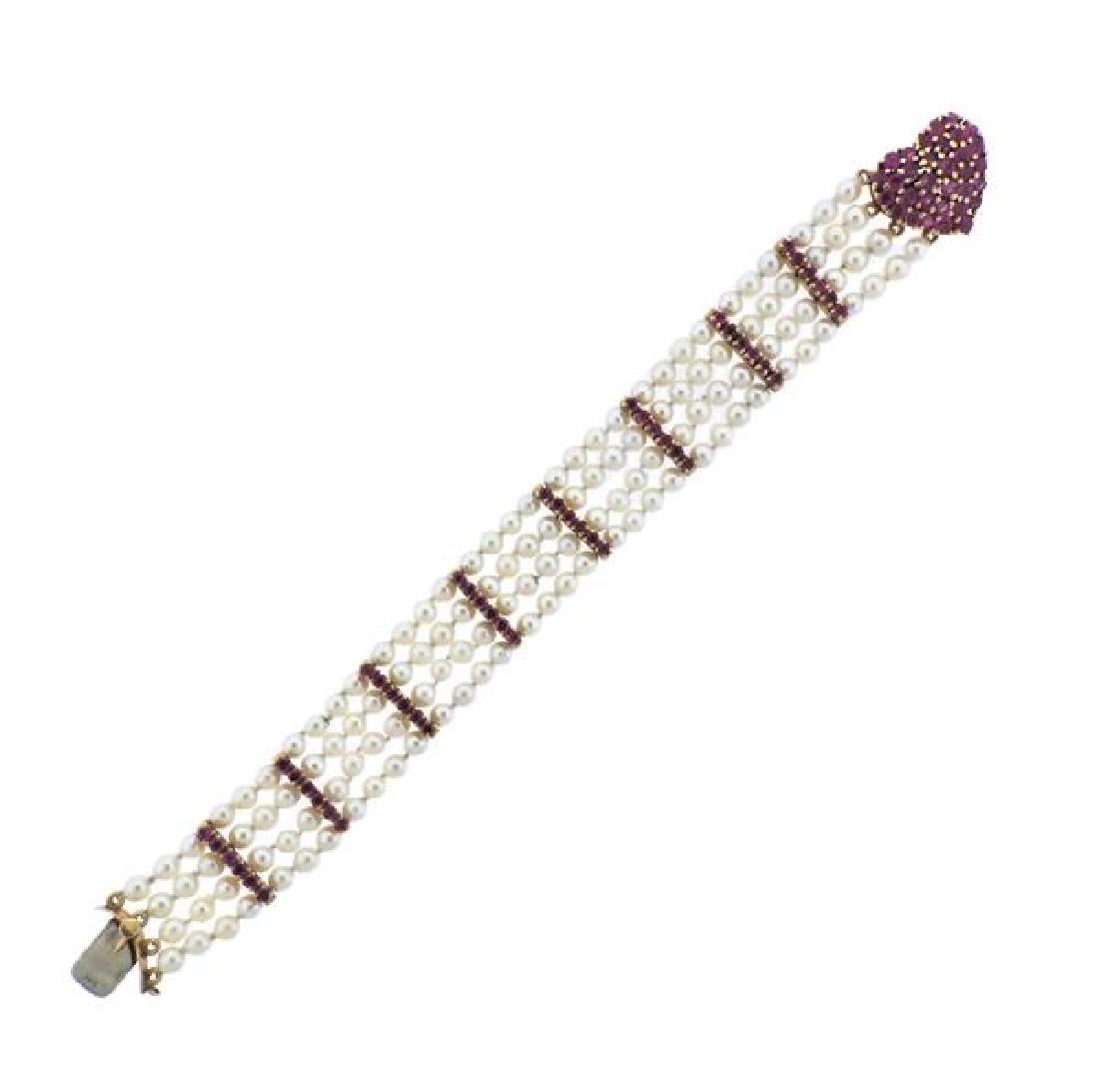 Vintage Tiffany & Co 14K Gold Pearl Red Stone: METAL: 14K gold. GEMSTONES: pearls 4mm, red stones. MEASUREMENTS: 4 strand bracelet is 6 3/4" long x 17mm at widest point. MARKED: 14K Tiffany & Co. WEIGHT: 25.4 grams.Gemstones have not been