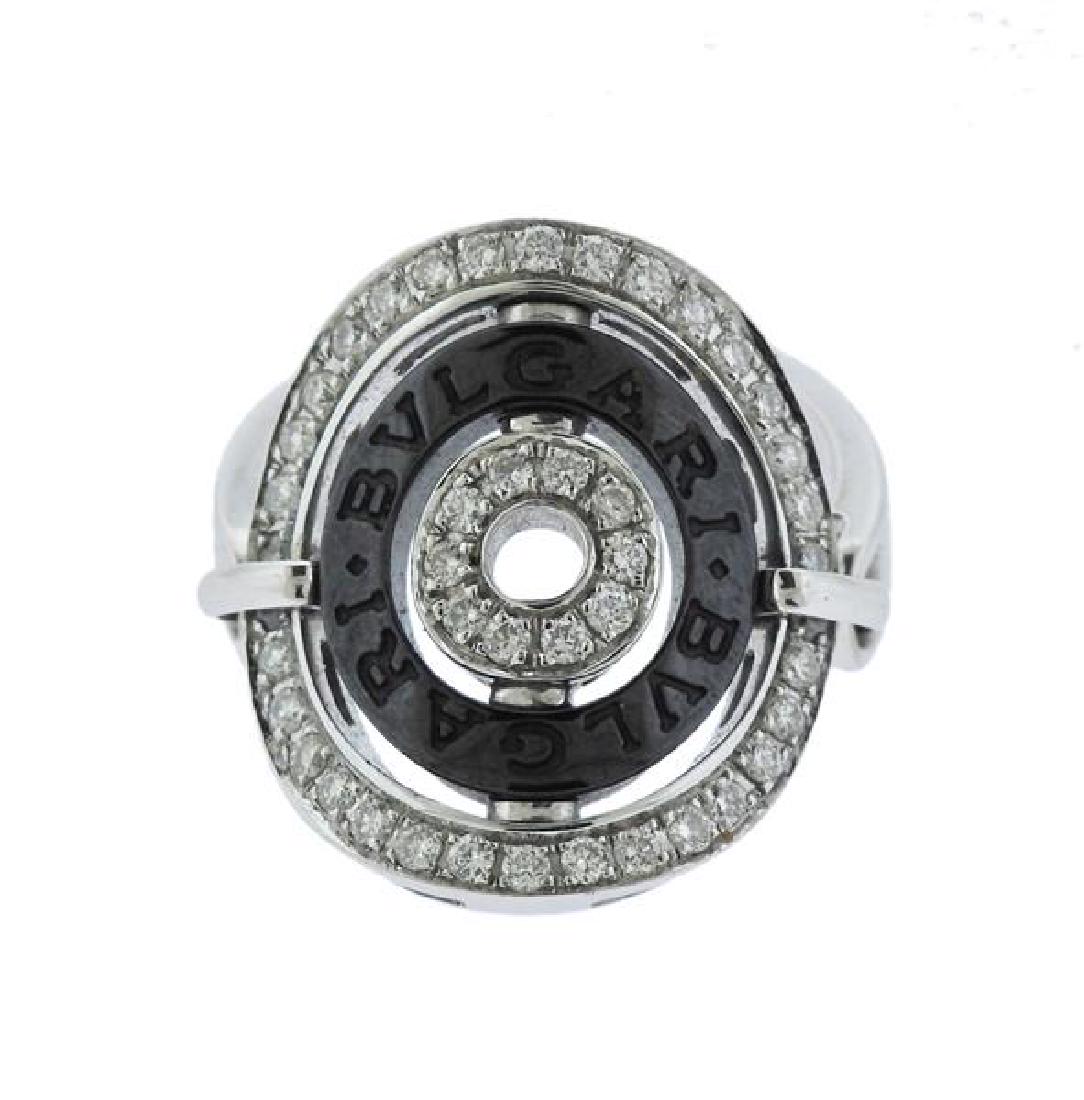 Bvlgari Bulgari Astrale 18K Gold Diamond Ceramic Flip: METAL: 18K gold. GEMSTONES: diamonds-approx. 0.70ctw, ceramic. MEASUREMENTS: ring size 7.25. Ring top is 21.5mm at widest point. MARKED/TESTED: Bvlgari, tested 18K. WEIGHT: 9.6 grams.Gemstones have no