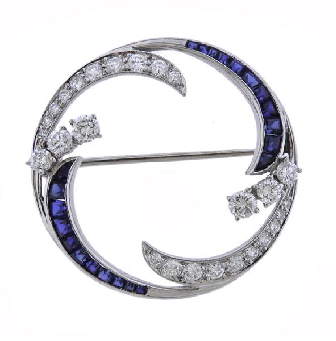 McTeigue Platinum Diamond Blue Stone Brooch: METAL: platinum. GEMSTONES: diamonds - approx. 1.00ctw, blue stones. MEASUREMENTS: brooch is 30mm in diameter. marked: Irid Plat McTeigue hallmark. WEIGHT: 7.6 grams.Gemstones have not been graded for