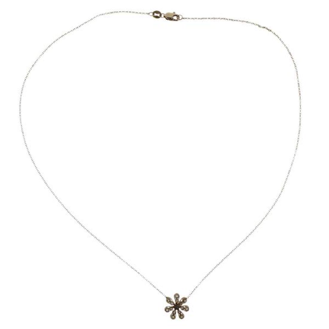 14K Gold Diamond Flower Pendant Necklace: METAL: 14K gold. GEMSTONES: diamonds. MEASUREMENTS: necklace is 16" long. Pendant is 11mm in diameter. MARKED: 14K Indonesia. WEIGHT: 1.6 grams.Gemstones have not been graded for color and clarit