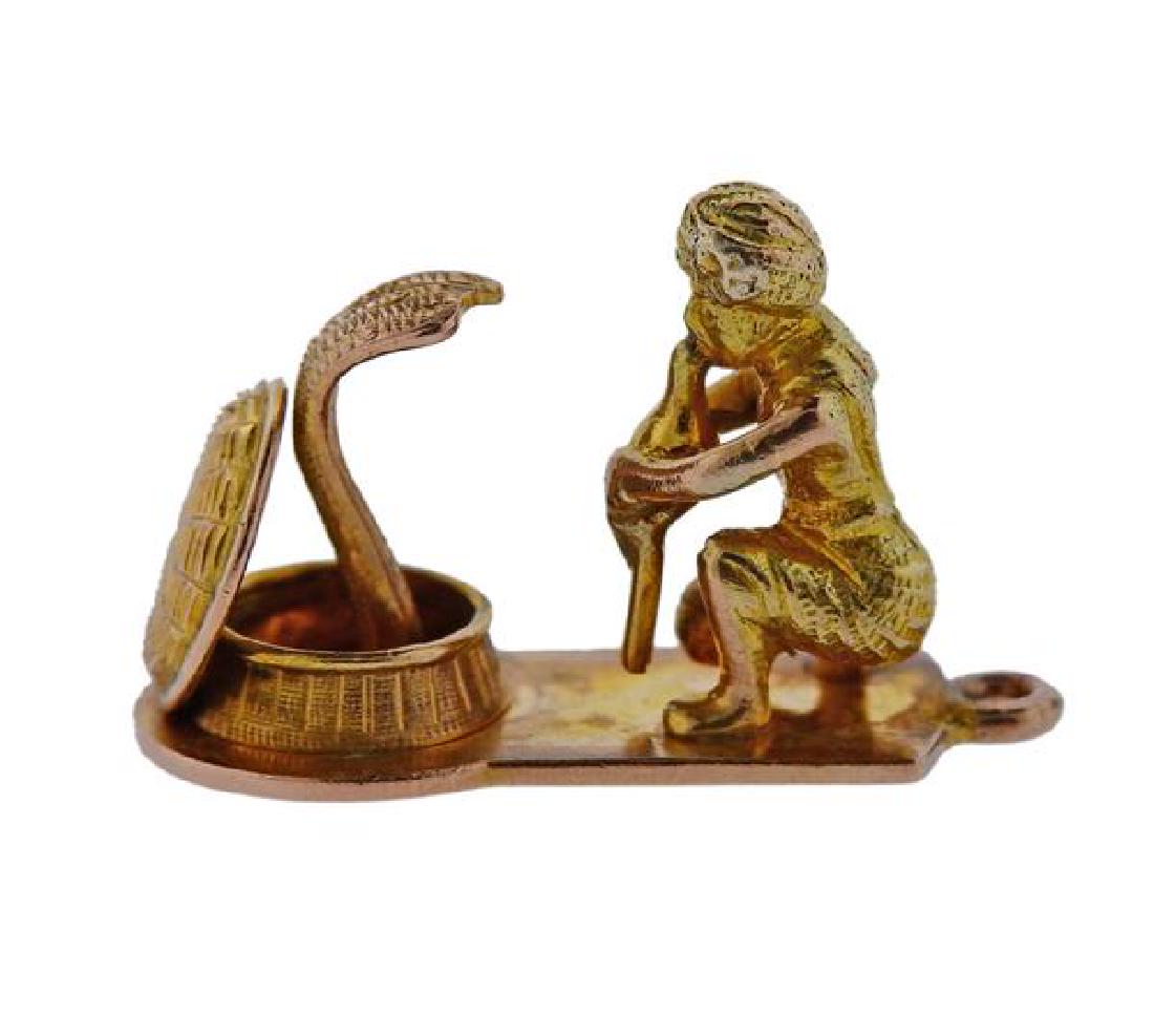 8K Gold Snake Charmer Charm Pendant: METAL: 8k gold. MEASUREMENTS: charm is 23 x11 x 15mm. Charm back has red marker's residue. MARKED: 8Ct. WEIGHT: 4.7 grams.Gemstones have not been graded for color and clarity ,and tested for clari