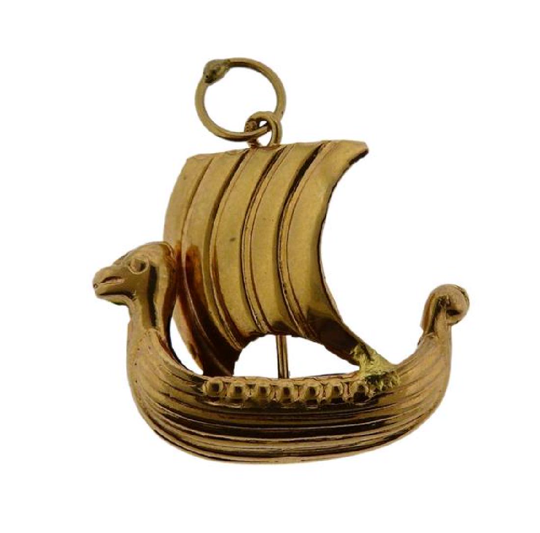 18K Gold Viking Ship Charm Pendant: METAL: 18K gold. MEASUREMENTS: charm is 21mm long x 21mm at widest point. TESTED: 18K, gold assay stamp. WEIGHT: 1.3 grams.Gemstones have not been graded for color and clarity ,and tested for clarity 