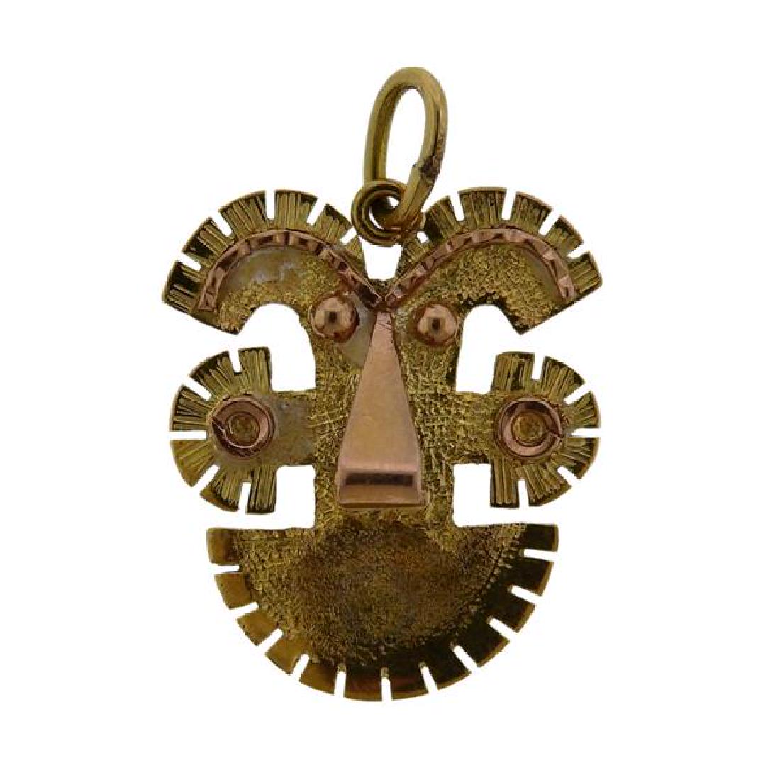 18K Gold Colombian Mask Charm Pendant: METAL: 18K gold. MEASUREMENTS: charm is 16mm long x 15mm at widest point. MARKED: 18K. WEIGHT: 1.3 grams.Gemstones have not been graded for color and clarity ,and tested for clarity and color enhancem