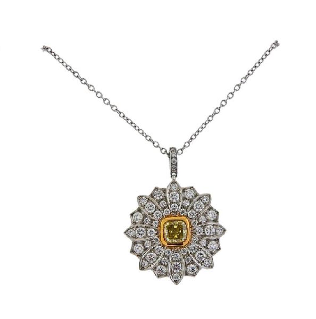 Tiffany & Co Daisy 18k Gold Platinum Yellow Diamond: METAL; 18k Gold/ Platinum. MEASUREMENTS: Necklace is 16" long, Pendant is 22mm x 17mm. GEMSTONES: White Diamonds approx. 0.58ctw, Yellow diamond approx. 0.37-0.38ct. MARKED: Tiffany & Co, pt9