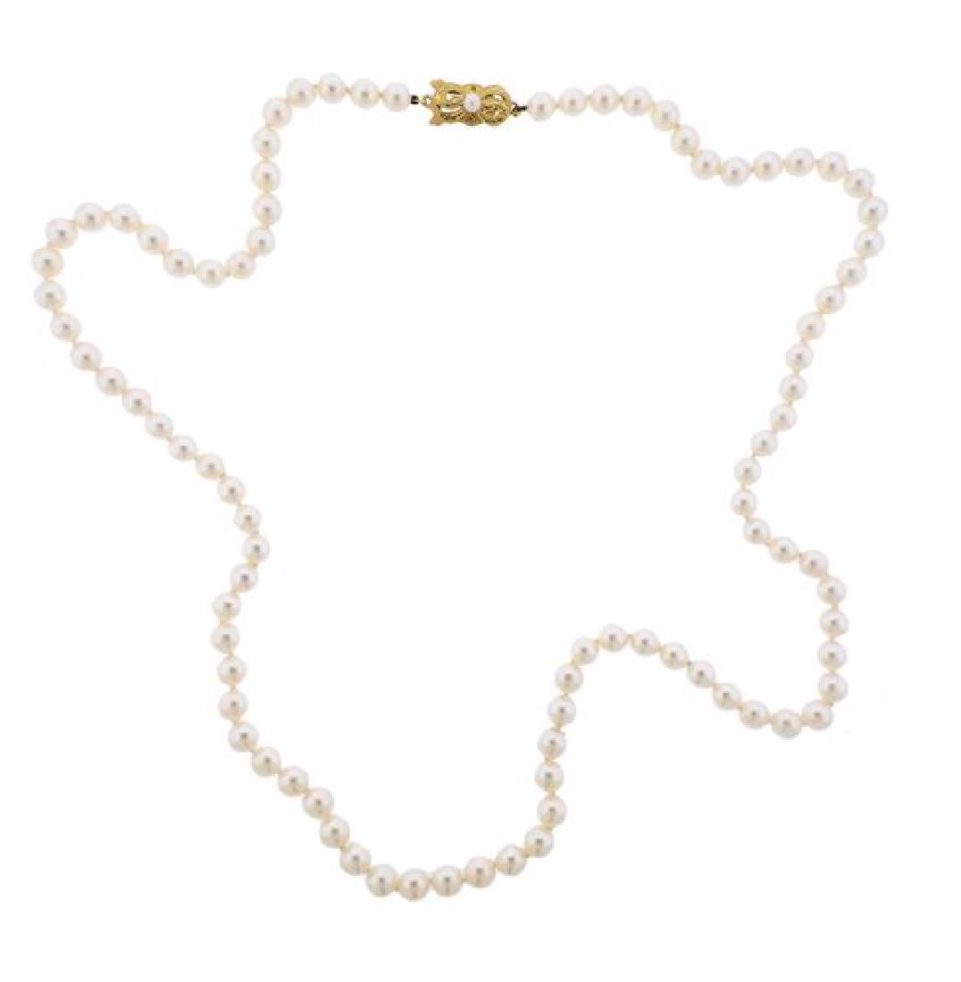 Mikimoto 18K Gold Pearl Necklace: METAL: 18k gold. GEMSTONES: pearls 6-6.5mm. MEASUREMENTS: necklace is 24" long. MARKED: 750, M- maker's mark. WEIGHT: 32.6 grams. Comes with booklet.Gemstones have not been graded for color a