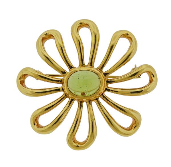 Tiffany & Co Picasso 18K Gold Peridot Flower Brooch: METAL: 18k Gold. GEMSTONES: Peridot cabochon. MEASUREMENTS: Brooch is 42mm x 39mm. MARKED: 1981 Tiffany & Co Paloma Picasso 18k 750. WEIGHT: 17.2 grams.Gemstones have not been graded for color and
