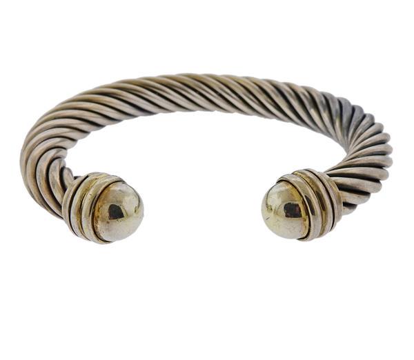 David Yurman 10mm Cable 14k Gold Silver Bracelet: METAL: 14k Gold/ Sterling Silver. MEASUREMENTS: Bracelet will fit approx. 7.5" wrist and is 10mm wide (cable part). Gold ends have small dents. MARKED: D. Yurman, 14k, Sterling. WEIGHT: 43.1 gram
