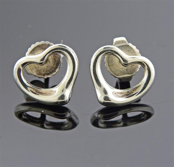 Tiffany & Co Elsa Peretti Silver Open Heart Stud: METAL: 925 Sterling Silver. MEASUREMENTS: Earrings are 10.7mm x 9mm. MARKED: Tiffany & Co Elsa Peretti 925 Spain. WEIGHT: 1.9 grams.Gemstones have not been graded for color and clarity ,and tested