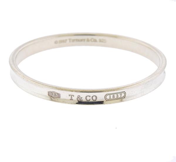 Tiffany & Co Sterling Silver 1837 Bracelet: METAL: Sterling Silver . GEMSTONES: none . MEASUREMENTS: Bracelet is 7mm in width. TESTED: 1997, Tiffany & CO, 925, 1837 WEIGHT: 31.75 grams.Gemstones have not been graded for color and clarity ,a