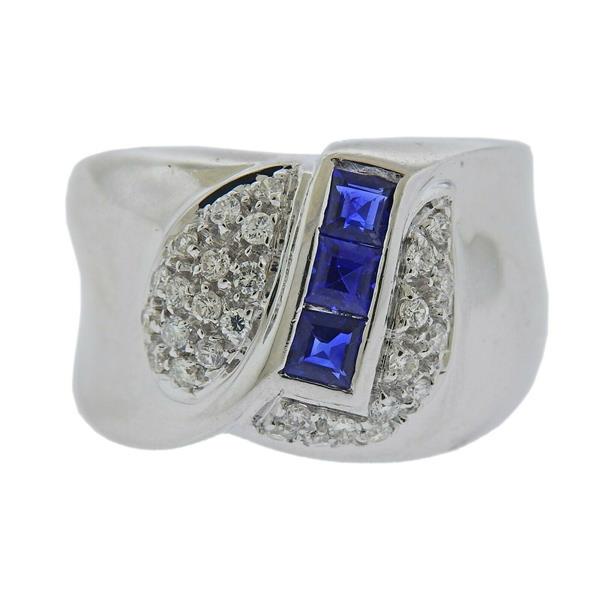 18k Gold Diamond Sapphire Ring: METAL: 18k Gold. MEASUREMENTS: Ring size 7.25. Band is 14 mm wide. GEMSTONES: Diamonds approx. 0.32ctw, sapphire. MARKED: Italian mark, 750. WEIGHT: 11. 2 grams.Gemstones have not been graded for colo