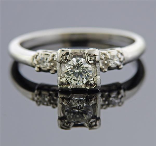 Platinum Diamond Engagement Ring: METAL: Platinum. GEMSTONES: Center diamond approx. 0.30ct , side diamonds approx. 0.05ctw. MEASUREMENTS: Ring size 6 1/4, ring top is 6.5mm at widest point. MARKED: 10%Irid Plat BHI2. WEIGHT: 4.5 gram