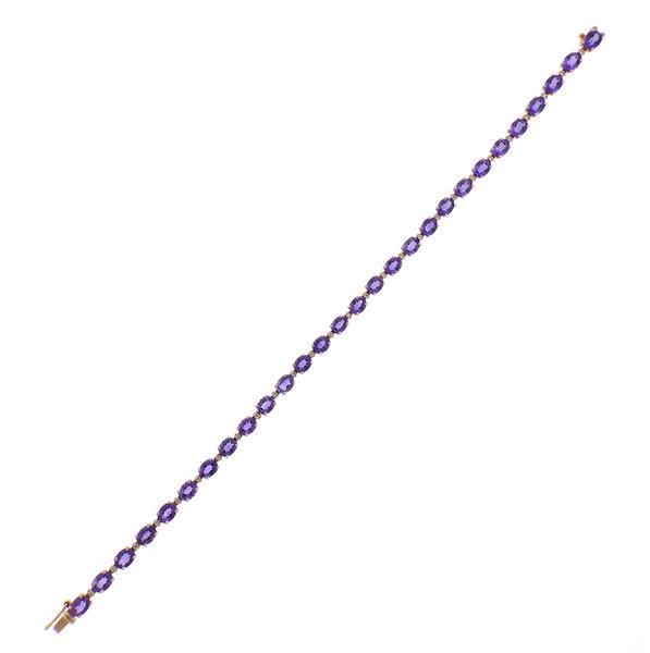 18K Gold Diamond Amethyst Bracelet: METAL: 18k Gold. GEMSTONES: Diamonds approx. 0.25ctw. Amethyst 8.10ctw - (5mm x 4mm). MEASUREMENTS: Bracelet is 7.75" long x 4mm wide. MARKED: 18k 750, 8.10, D0.25. WEIGHT: 10 grams.Gemstones hav