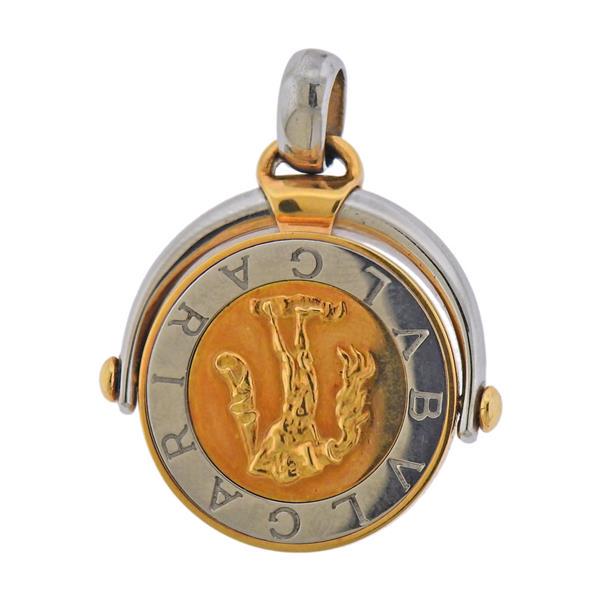 Bvlgari Bulgari 18K Gold Steel Aquarius Zodiac Flip: METAL: 18k Gold and Stainless Steel. MEASUREMENTS: Pendant is 35mm long with bale x 27mm wide. MARKED: Bvlgari BB Serial number. WEIGHT: 13.2 grams.Gemstones have not been graded for color and clarity
