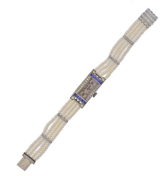 Art Deco 18k Gold Pearl Diamond Lady's Watch: METAL: 18k Gold. MEASUREMENTS: Case - 13.5mm x 30mm. Bracelet is 5 7/8" long. Decorated with synthetic sapphires, pearls and approx. 0.60ctw in diamonds. MOVEMENT: Manual wind - working order. WE