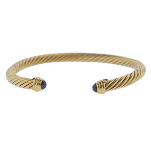 David Yurman 18k Gold Iolite Cuff Bracelet: METAL: 18k Gold. GEMSTONES: Iolite (stone is chipped/abraded). MEASUREMENTS: Bracelet will fit 7" wrist and is 6.6mm at widest point. MARKED: D. Y. 18k. WEIGHT: 14.2 grams.Gemstones have not