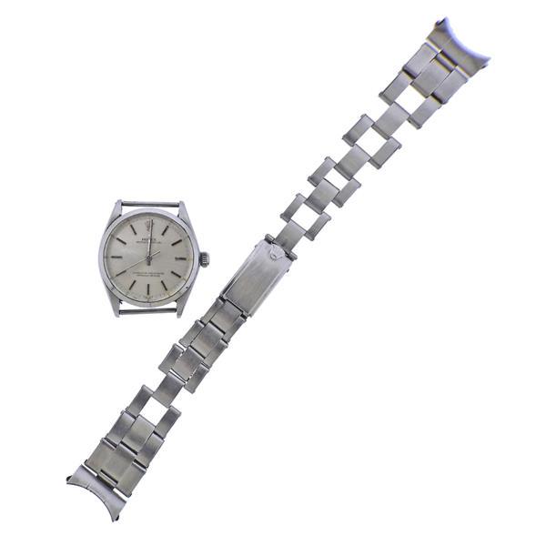 Rolex 1950s Oyster Stainless Steel Watch 1002: METAL: Stainless Steel. MEASUREMENTS: Case 34mm, with detached vintage oyster band, shoes stretching. Band is 7 1/8" long. Scratches on crystal. Silvered dial with stick markers. MOVEMENT: Automa