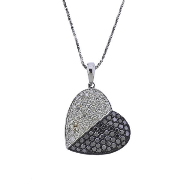 14k Gold Black White Diamond Heart Pendant Necklace: METAL: 14k Gold. MEASUREMENTS: Necklace is 20" long, pendant is 29mm x 21mm. GEMSTONES: Black and white diamonds. MARKED: 14k. WEIGHT: 7.8 grams.Gemstones have not been graded for color and clari