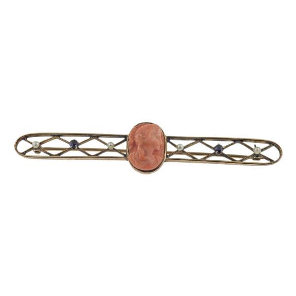 Antique 14k Gold Coral Cameo Sapphire Pearl Brooch: METAL: 14k Gold. MEASUREMENTS: Brooch is 75mm x 15mm. GEMSTONES: Coral, Sapphire, Pearl. MARKED: 10k on stem. Brooch tested 14k. WEIGHT: 6.5 grams.Gemstones have not been graded for color and clarity 