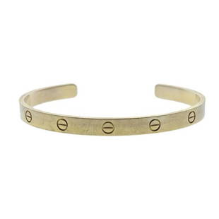 Cartier Love 18K Gold Cuff Bracelet: METAL: 18k Gold. MEASUREMENTS: Bracelet size 20 and is 6.2mm wide (bracelet needs polishing/cleaning). MARKED: Cartier 20, 750, EQ3601. WEIGHT: 30.4 grams. Comes with COA. Retail $4950.Gemstones have