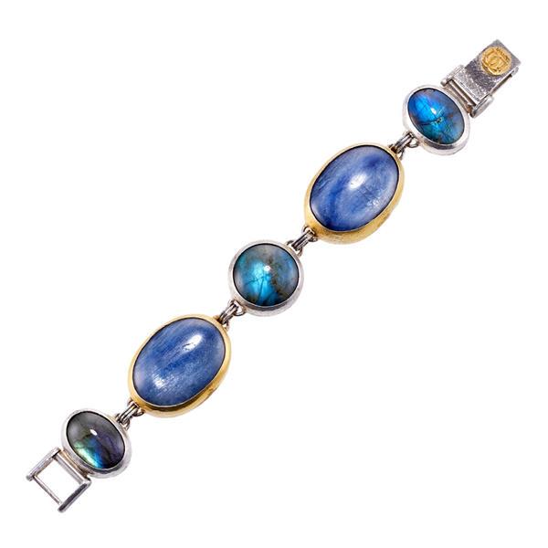Gurhan Silver 14k Gold Labradorite Bracelet: METAL: Sterling Silver/ 24k Gold. MEASUREMENTS: Bracelet is 7" long and 24mm wide. GEMSTONES: Labradorite. MARKED: Gurhan mark. WEIGHT: 58 grams.Gemstones have not been graded for color and clari