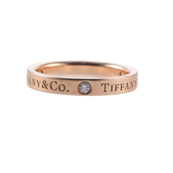 Tiffany & Co 18k Gold Diamond Band Ring: METAL: 18k Gold. GEMSTONES: Diamonds approx. 0.09ctw. MEASUREMENTS: Ring size 5 3/4, band is 3mm. Ring needs polishing. MARKED: Tiffany & Co Au750. WEIGHT: 3.7 grams. Retail $2250.Gemstones have n