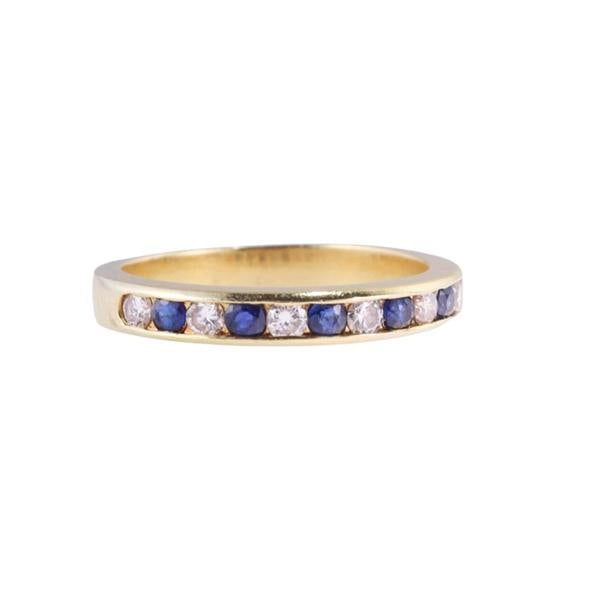 18k Gold Diamond Sapphire Band Ring: METAL: 18k Gold. GEMSTONES: Diamonds approx. 0.24ctw. Sapphire. MEASUREMENTS: Ring size 6 1/2, band is 3.2mm wide. MARKED: 18k. WEIGHT: 3.7 grams.Gemstones have not been graded for color and clarity, 