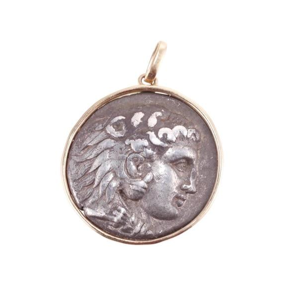 18k Gold Silver Coin Pendant: METAL: 18k Gold and Silver. MEASUREMENTS: Pendant is 36mm long with bail x 27mm in diameter. TESTED: 18k, Silver. WEIGHT: 19.5 grams.Gemstones have not been graded for color and clarity, and tested fo