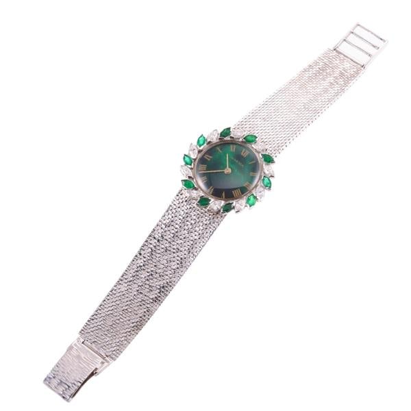 Juvenia 14k Gold Diamond Emerald Lady's Watch: METAL: 14k Gold. MEASUREMENTS: Case 30mm, bezel decorated with marquise diamonds and emeralds. 14k gold band - 6.5" long. Green dial with gold Roman markers. Specks on the crystal. MOVEMENT: Manu