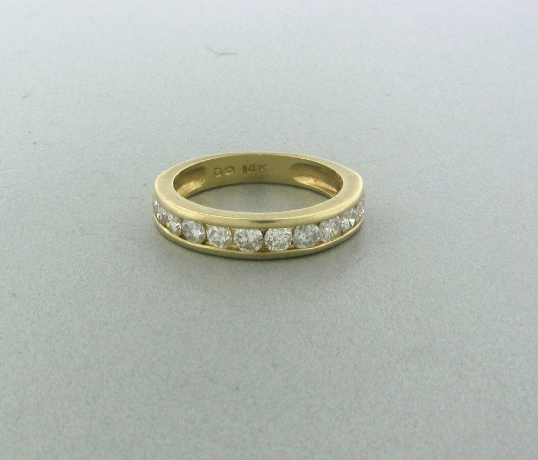 073: 14k Gold Diamond Wedding Ring: 12 diamonds, Approx: 0.75 -0.85ctw. weight: 3.0g, approx. size 6 1/2. Diamond go around half of band