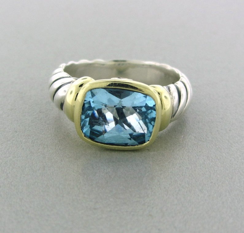 046: David Yurman Sterling Silver 14k Gold Blue Topaz: Measurements - ring size 6 1/4, ring is 9.5mm wide. Blue topaz - 7.5mm x 10mm. marks - D.Y.,925,585. weight - 7.2 grams.