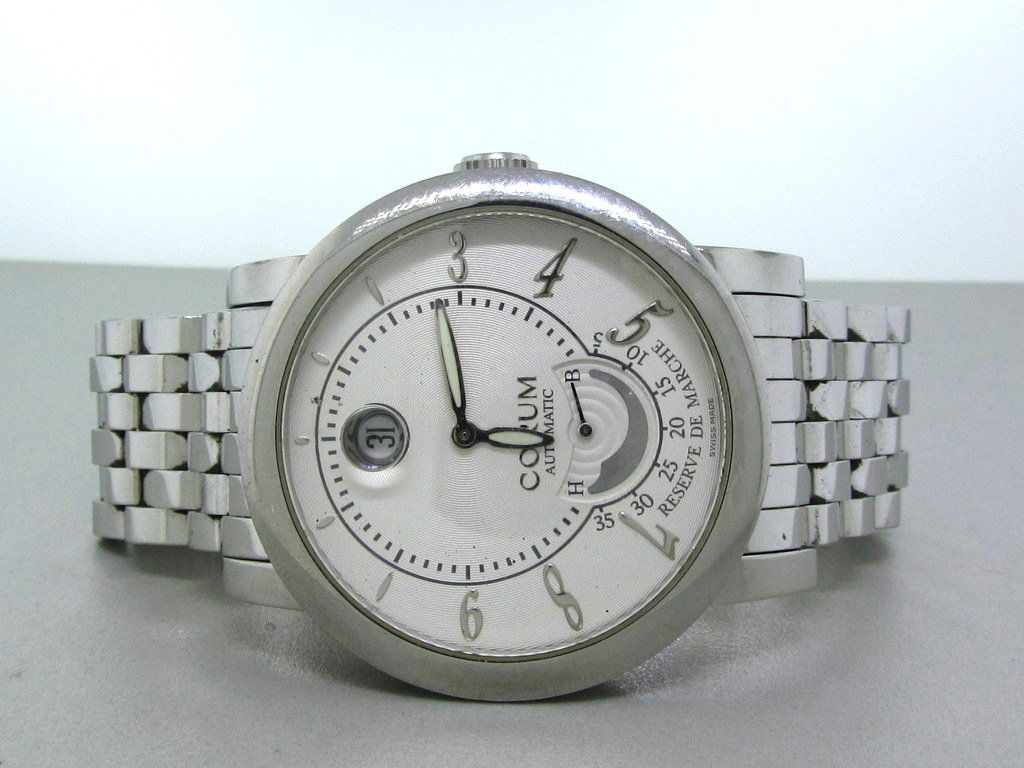 Corum Grand Date Power Reserve De Marche Watch: Gender - Mens. Movement- Automatic. Functions Hour, Minute, Power Reserve, Date. Case Material Stainless Steel. Case Diameter 42mm Bracelet Stainless Steel, Fits 7.25" Wrist. Crystal Scratch Resistant