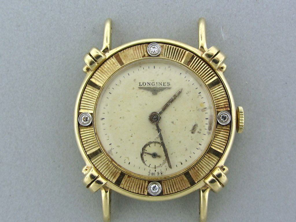 Vintage 14k Gold Longines diamond watch: 14k Yellow gold case with fancy lugs , 4 diamonds bezel. Manual wind movement 17jewels. . Case , movement and dial signed by Longines.