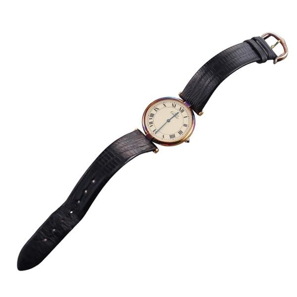 Cartier Vermeil Watch: METAL: Vermeil. MEASUREMENTS: Case 30mm, patina present on the case. band non original, buckle shows patina. Cartier yellow dial with Roman markers. MOVEMENT: Quartz - not working. Watches are guarant