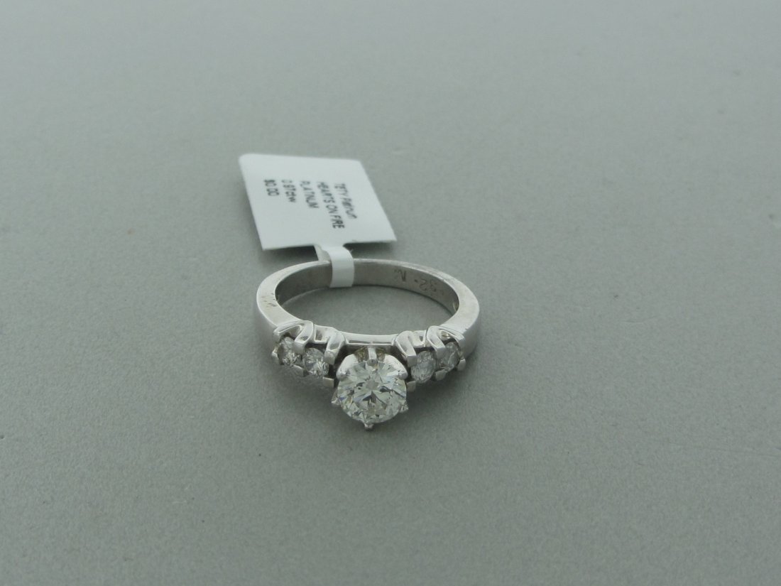 Hearts On Fire Platinum Diamond Engagement Ring: Measurements - ring size 5 1/2. Center Diamond Is AGS Certified 0.651CT SI1 /I - Ideal Cut,Mounting Set With 0.32ctw 4 Diamonds Clarity:Center -SI1. Mount -VS1 Color: Center - I, Mount G/H Weight:7.3g